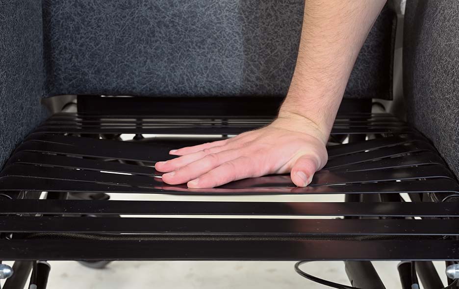 Hand pressing on the comfort tension seating