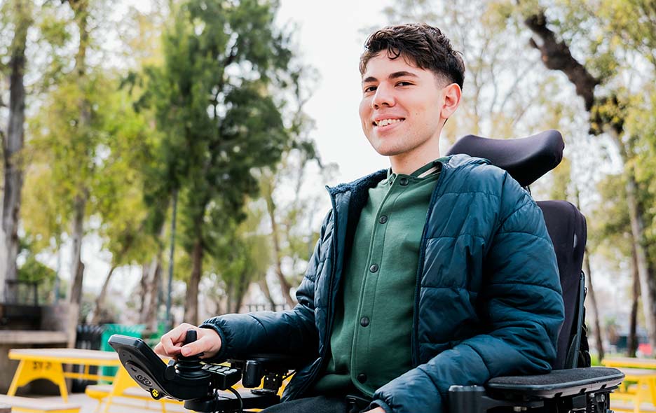 A young teen navigating the outdoors in his wheelchair