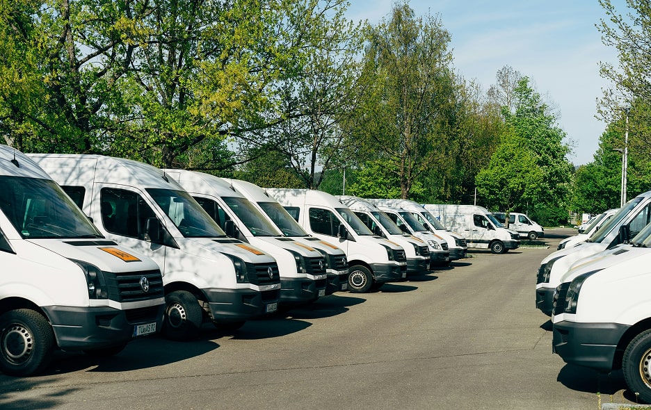 A fleet of transport vans in a lot.