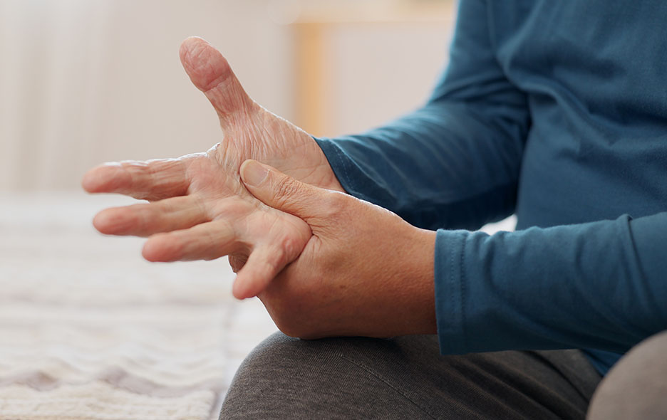 Close up of a person clutching their hand