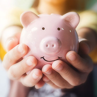 Hands holding a piggy bank