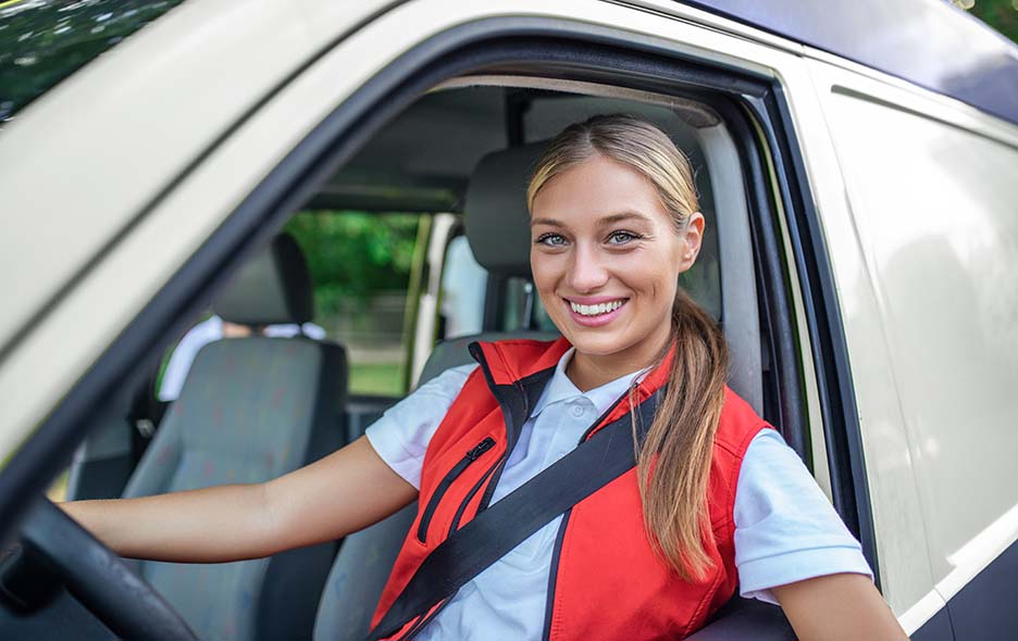 NEMT driver smiling from the driver's seat