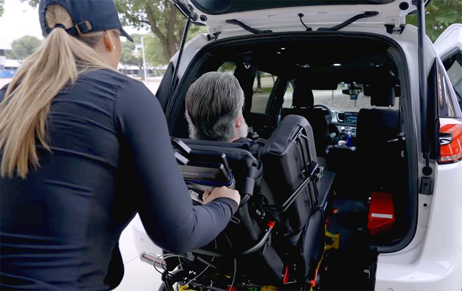 NEMT operator helping a patient up an access ramp