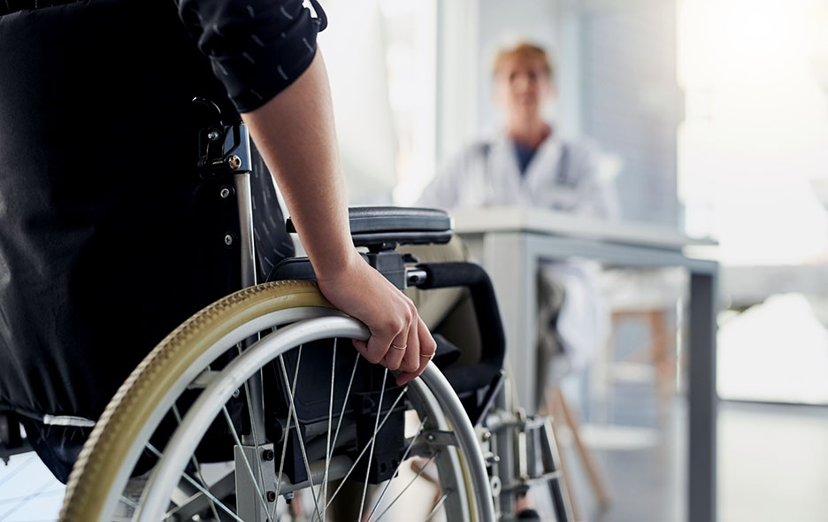 A person utilizing a wheelchair as they enter their doctor appointment