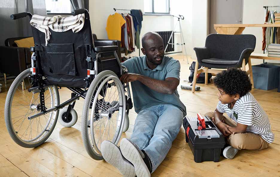 Father and son repairing a wheelchair
